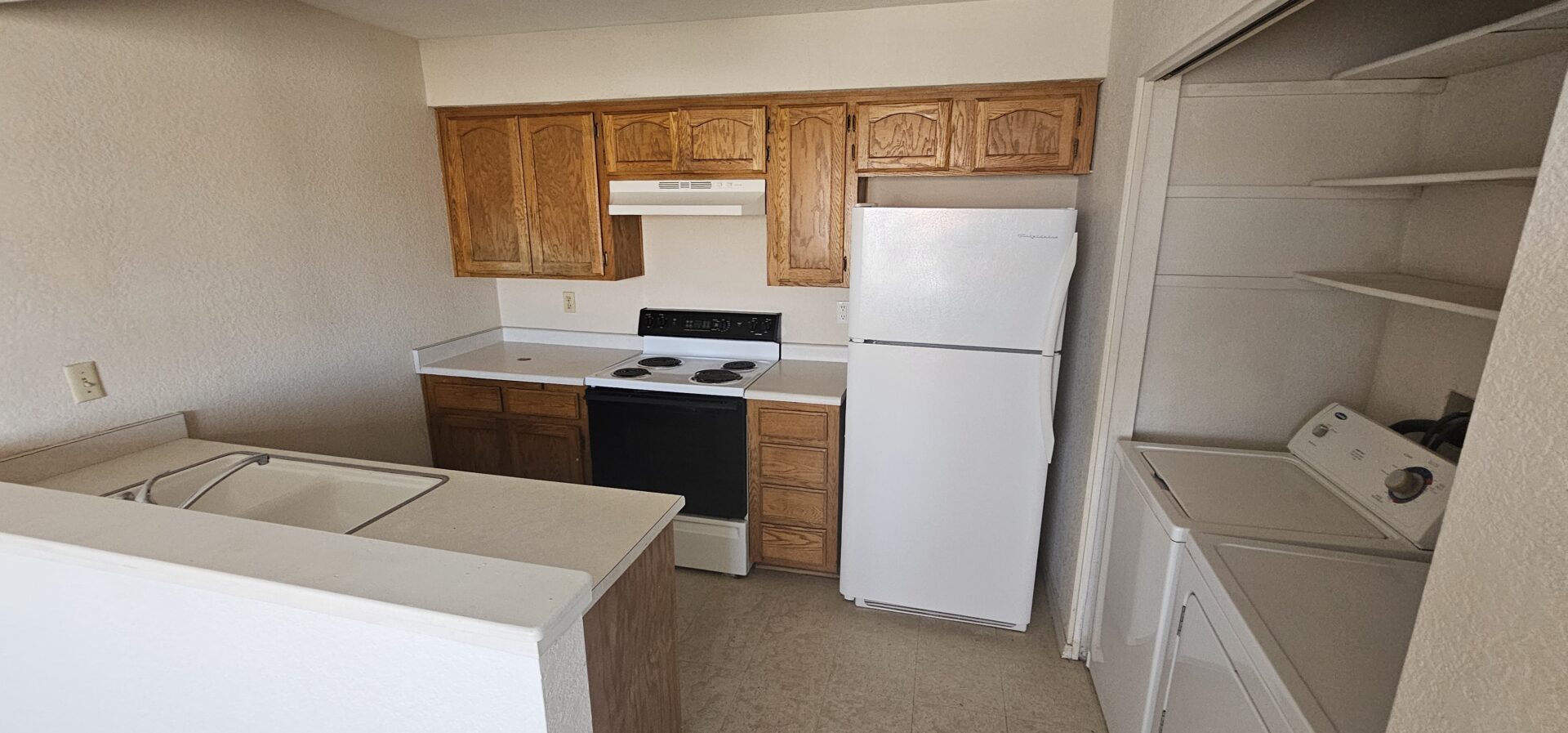 Small kitchen with appliances and laundry.