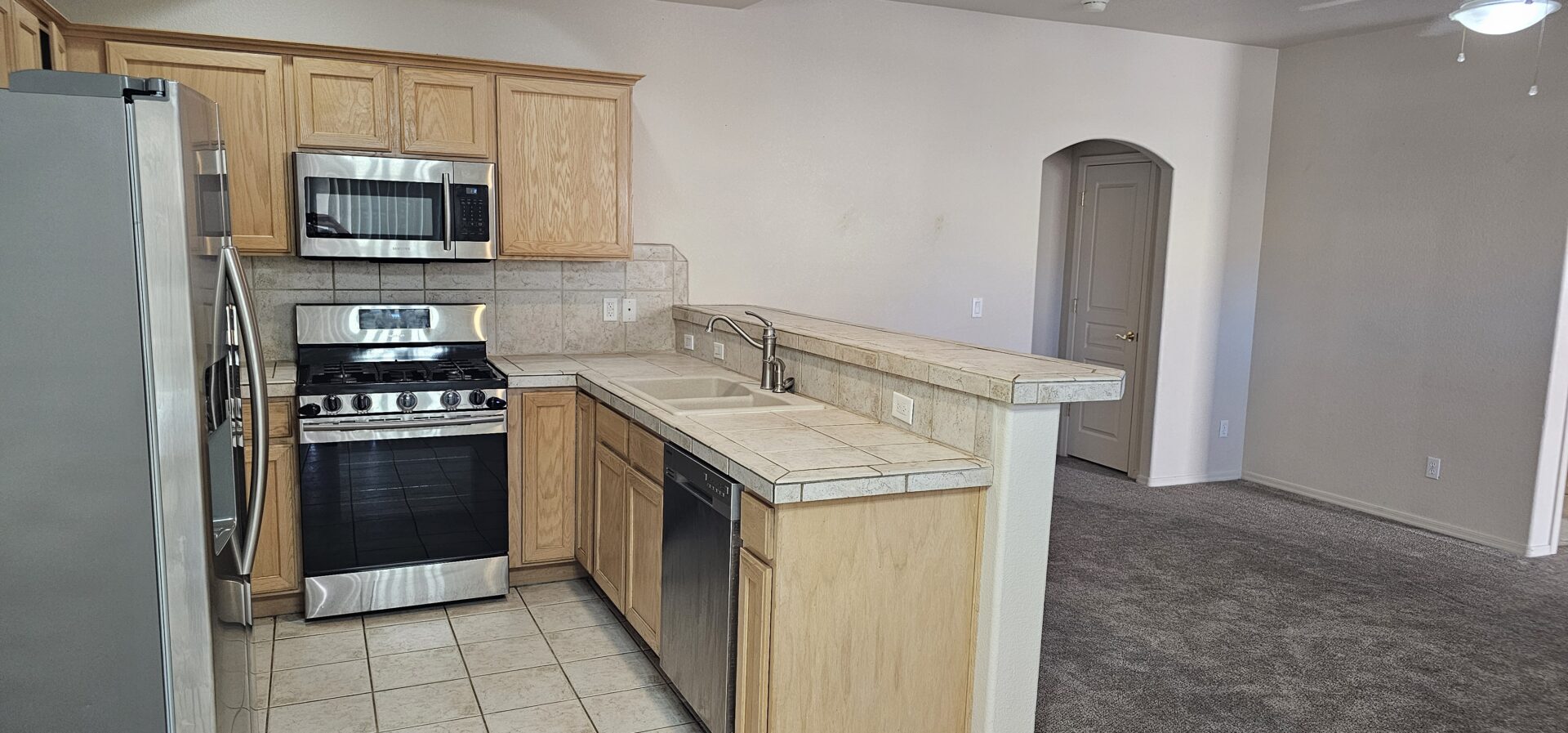 Modern kitchen with stainless steel appliances.