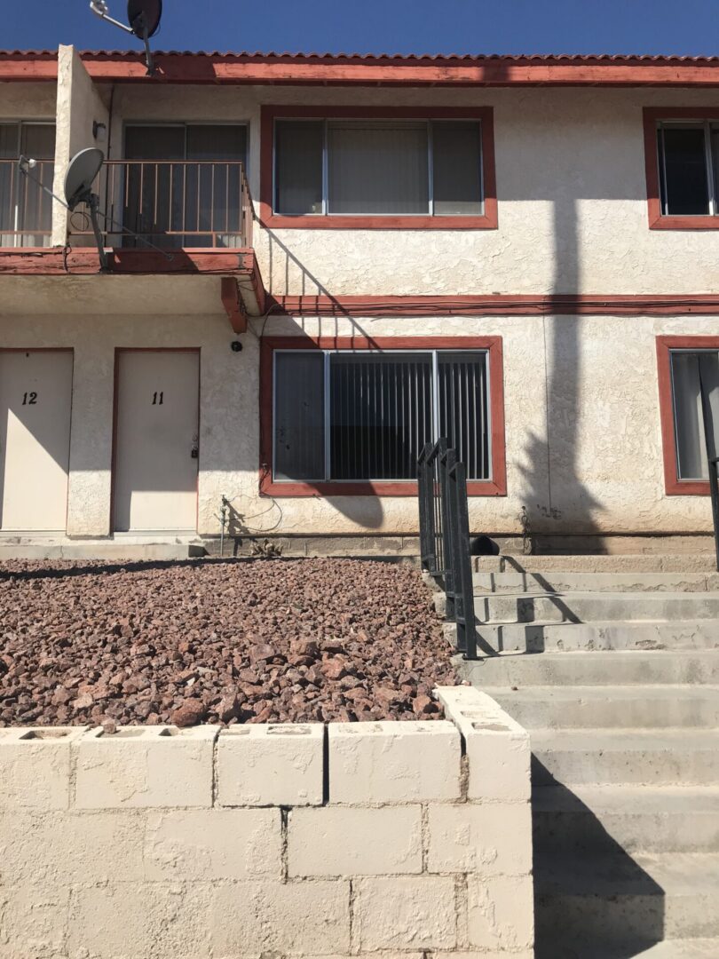 Apartment building with rock landscaping.