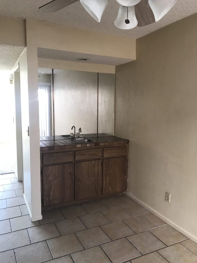 Wood wet bar with tiled countertop.