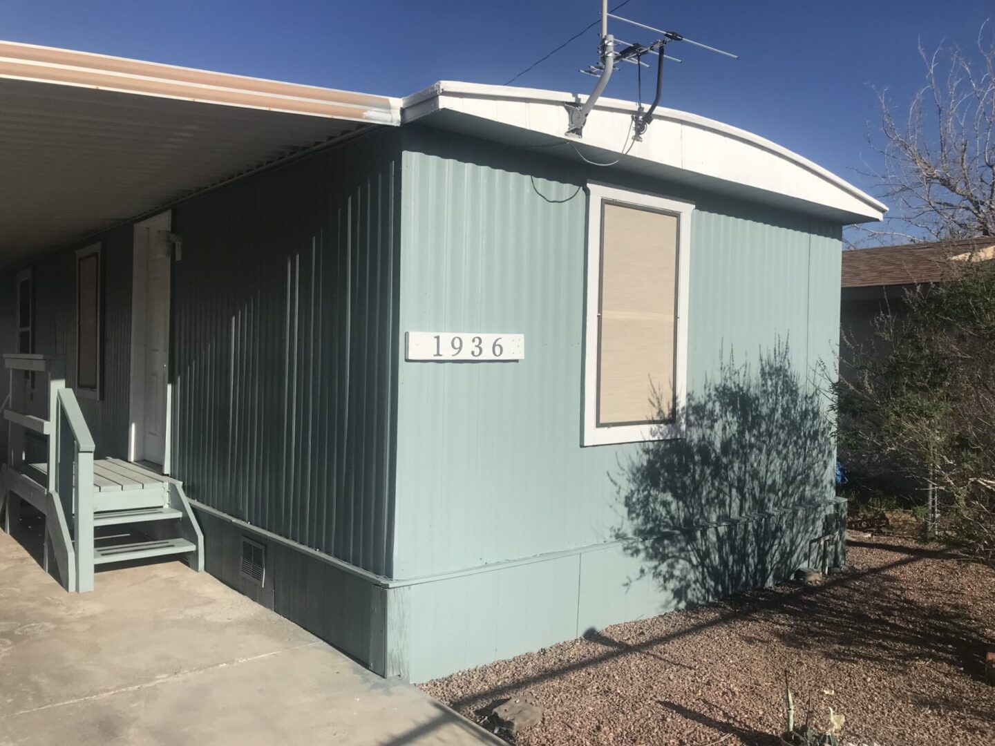 Here's an alt tag for the image: Light blue mobile home, number 1936.
