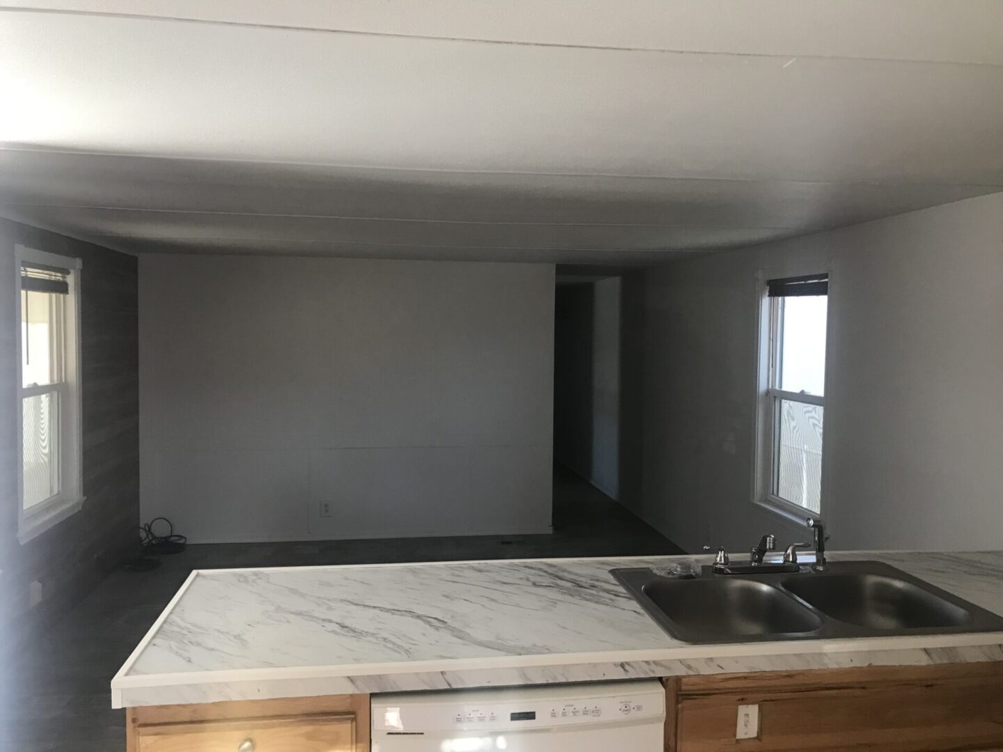 Empty mobile home kitchen interior.