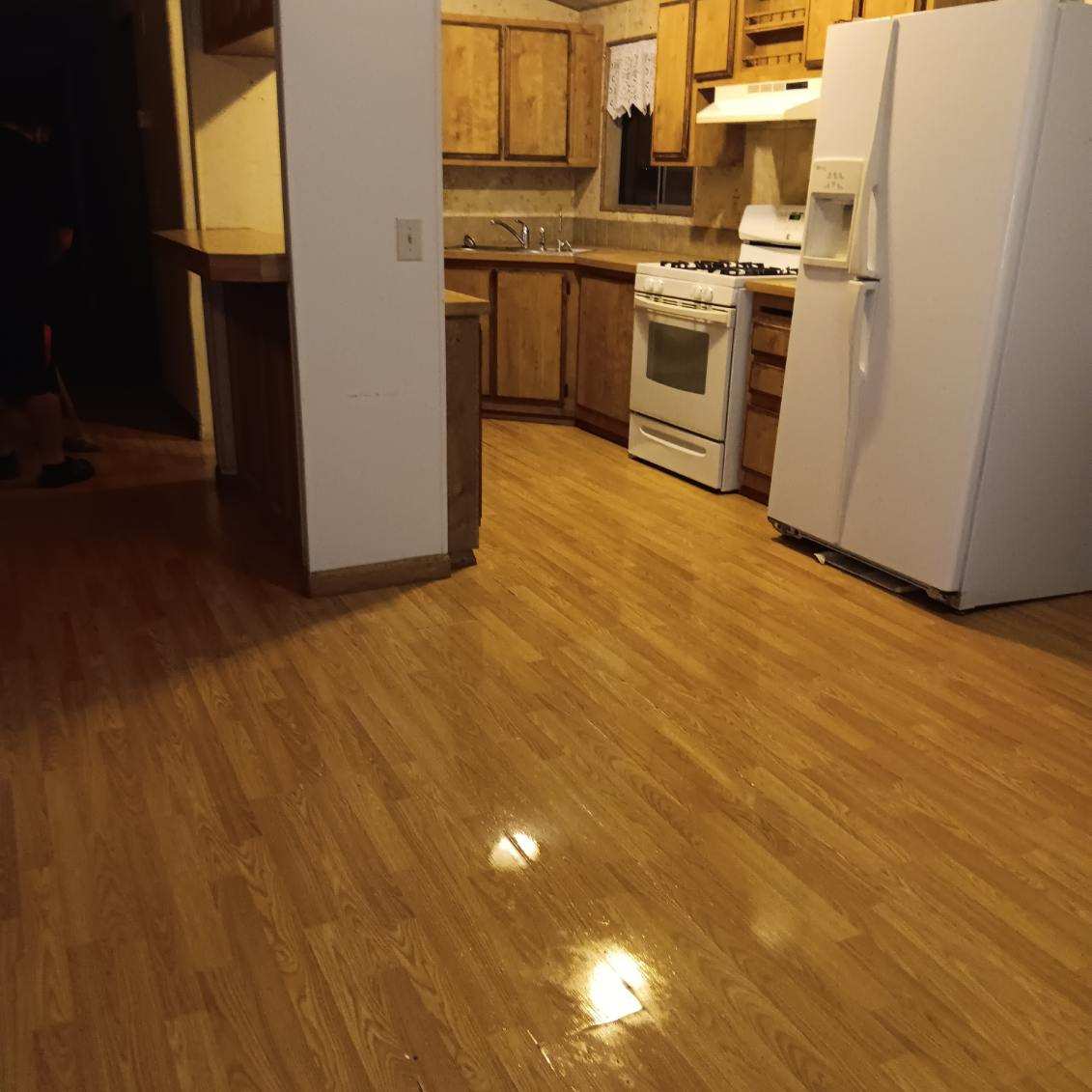 Kitchen with wooden cabinets and shiny floor