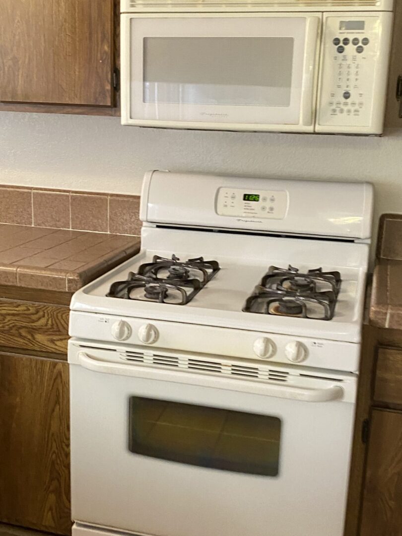 White gas stove with oven and microwave