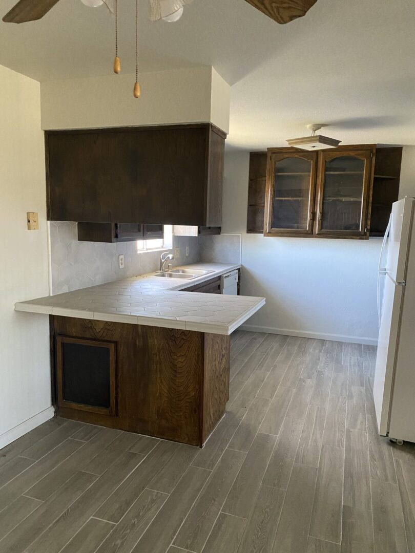 Kitchen with wooden cabinets and tiled peninsula